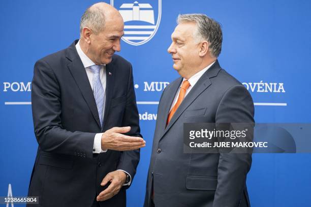 Slovenia's Prime Minister Janez Jansa welcomes his Hungary's counterpart Viktor Orban prior to the start of their meeting in Lendava, a city with a...