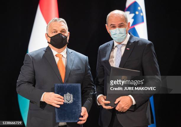 Slovenia's Prime Minister Janez Jansa and his Hungary's counterpart Viktor Orban pose after signing a treaty on cooperation in the economic and...