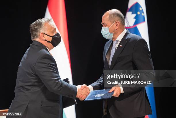 Slovenia's Prime Minister Janez Jansa and his Hungary's counterpart Viktor Orban shake hands after they signed a treaty on cooperation in the...