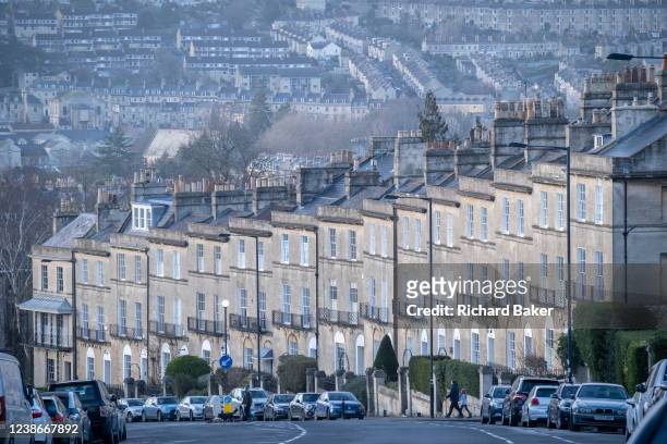 Seen from Bathwick Hill are foreground terraced homes at Dunsford Place on Bathwick Hill and in the distance, a cityscape of hillside properties...