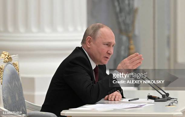Russian President Vladimir Putin chairs a meeting with members of the Security Council in Moscow on February 21, 2022. - President Vladimir Putin...