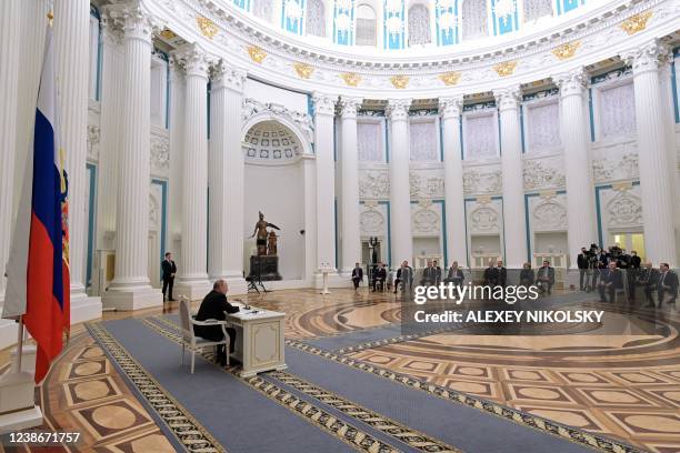 Russian President Vladimir Putin chairs a meeting with members of the Security Council in Moscow on February 21, 2022. - President Vladimir Putin...