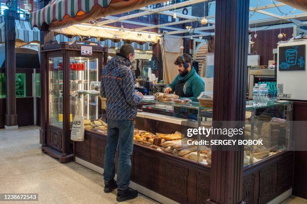 Man shops in a bakery in the center of Ukraine's second largest city of Kharkiv, some 40km from the Ukrainian-Russian border on February 21 as...