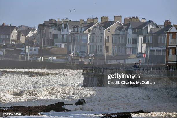 Locals look out at the sea foam blown up on to the prom due to Storm Franklin on February 21, 2022 in Portstewart, United Kingdom. Storm Franklin,...