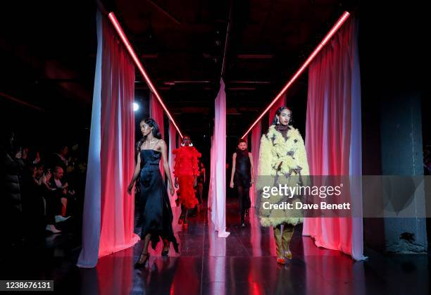 Models walk the runway at the Feben show during London Fashion Week February 2022 at the BFC NEWGEN Show Space on February 21, 2022 in London,...