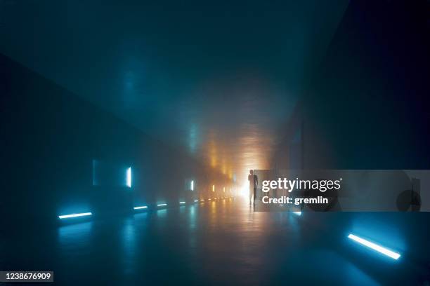 woman walking in dark tunnel - bunker stock pictures, royalty-free photos & images