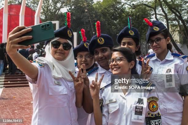 Group of volunteers BNCC pose for a selfie at the Martyr's Monument, or Shaheed Minar during the International Mother Language Day in Dhaka....