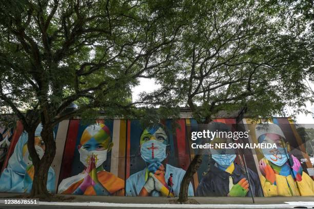 View of Brazilian artist Eduardo Kobra's work "Coexistencia" -which shows children wearing face masks due to the new coronavirus, COVID-19, bearing...