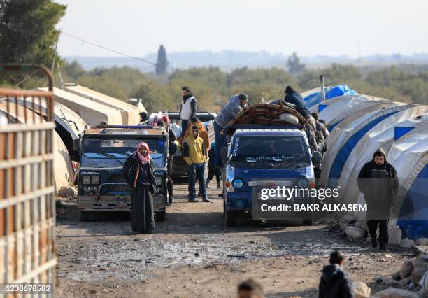 Internally displaced Syrians load their belongings onto a truck at a camp, before being transported to a new housing complex in the opposition-held...