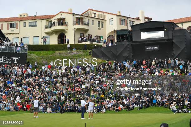 The final group is on the 18th green during the final round of The Genesis Invitational on February 20 at Riviera Country Club in Pacific Palisades,...