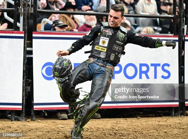 Jose Leme celebrates his qualified ride on the bull WSM's Trail of Tears by punting away his helmet in the second round during the PBR TicketSmarter...