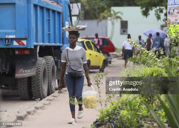 Local woman walks with a fruits basket on her head as daily life continues in Kinshasa, Democratic Republic of Congo on February 19, 2022. Congo, a...