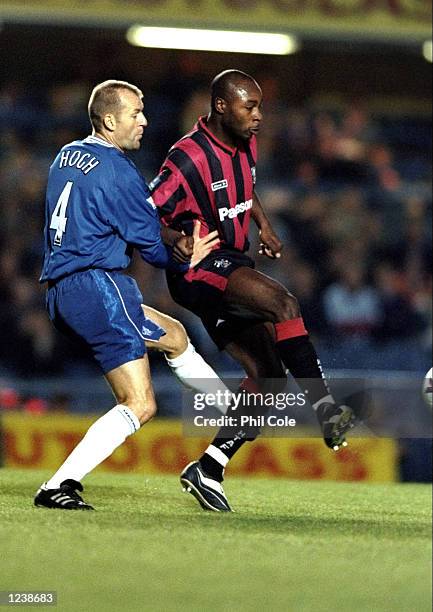 Clyde Wijnhard of Huddersfield Town holds off Jes Hogh of Chelsea during the Worthington Cup Third Round match at Stamford Bridge in London....