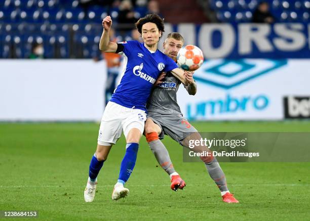 Ko Itakura of FC Schalke 04 and Felix Platte of SC Paderborn 07 battle for the ball during the Second Bundesliga match between FC Schalke 04 and SC...