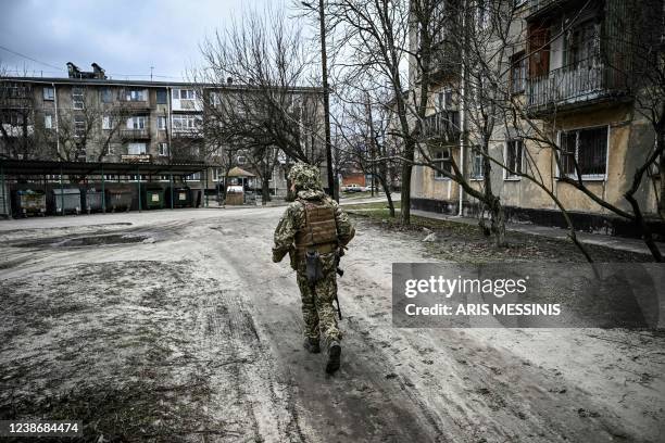 Ukraine army soldier walks in the town of Schastia, near the eastern Ukraine city of Lugansk, on February 22 a day after Russia recognised east...