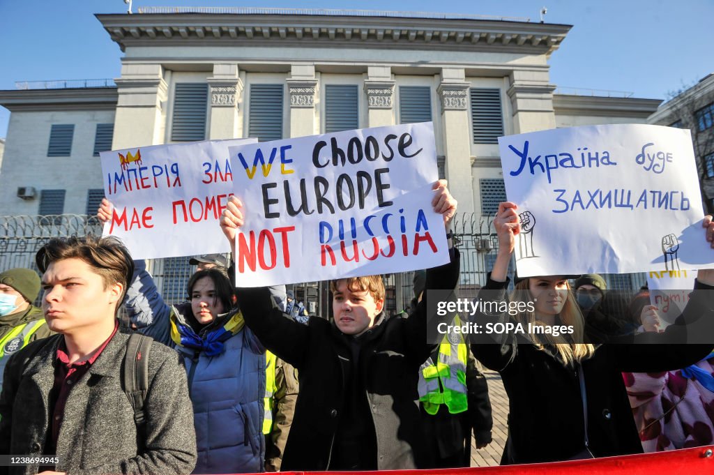 Ukrainian protesters seen holding placards expressing their...