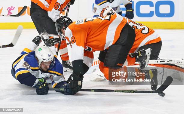 Rasmus Ristolainen of the Philadelphia Flyers and Vladimir Tarasenko of the St Louis Blues fall to the ice while battling for control of the puck in...