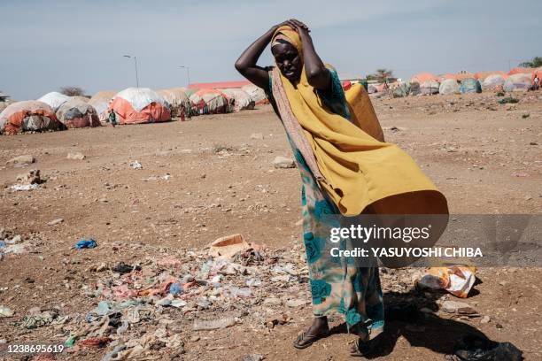 Woman carries a water container at a camp for internally displaced persons in Baidoa, Somalia, on February 13, 2022. Insufficient rainfall since late...