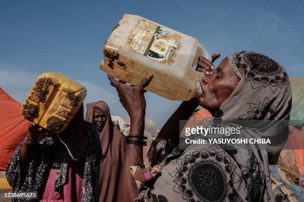 Hawa Mohamed Isack drinks water at a water distribution point at Muuri camp, one of the 500 camps for internally displaced persons in town, in...