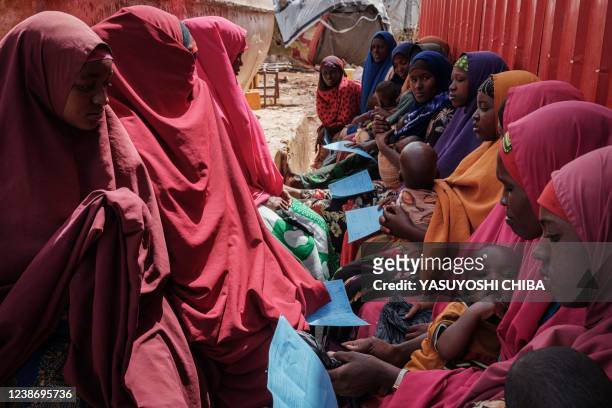 Mothers wait for high nutrition foods and health services at Tawkal 2 Dinsoor camp for internally displaced persons in Baidoa, Somalia, on February...