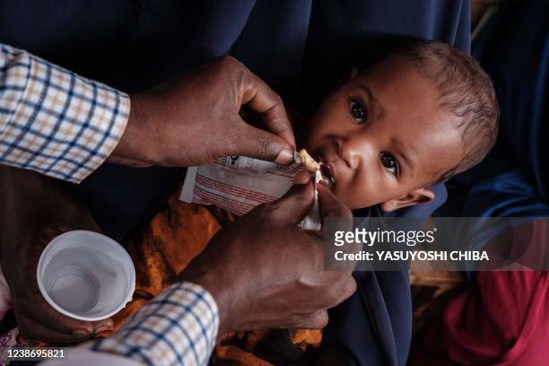An eight-month-old child receives high nutrition foods at Tawkal 2 Dinsoor camp for internally displaced persons in Baidoa, Somalia, on February 14,...