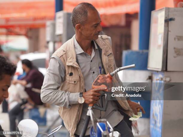 Man refuels his vehicle during current fuel crisis in Taiz, Yemen on February 20, 2022. Fuel went on the black market due to fuel crisis caused by...