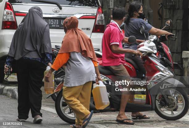 Hundreds of people line up to get cooking oil in Rawamangun, Jakarta, Indonesia on February 23, 2022. The cheap market holds in Rawamangun, East...