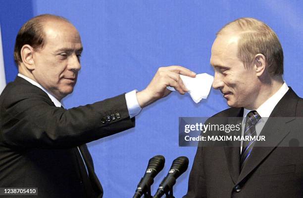 Italian Prime Minister Silvio Berlusconi jokes with Russian President Vladimir Putin during a joint press conference in Lipetsk, some 400 km south of...