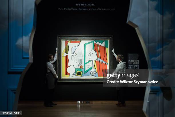 Staff members hold 'La fenetre ouverte' by Pablo Picasso , estimate: £14 000 - 24 000 during a photo call to present the highlights from the 20th /...