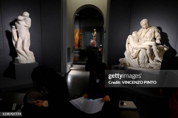 Photograph taken on February 23, 2022 shows Michelangelo's casts of so-called "Rondanini" Pieta and the Vatican Pieta during a preview of the...
