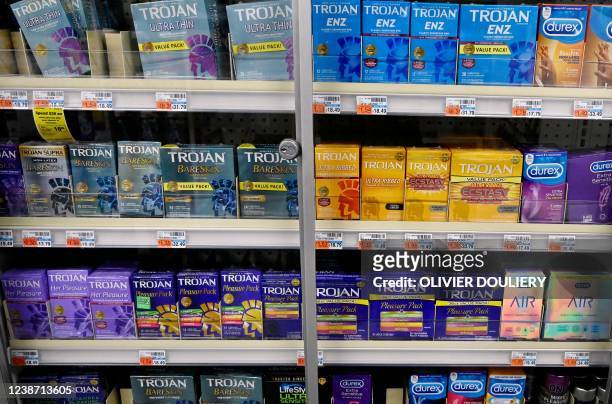 Packs of various condoms stand on a shelf of a CVS store in Washington, DC, on February 23, 2022. The US Food and Drug Administration has authorized...