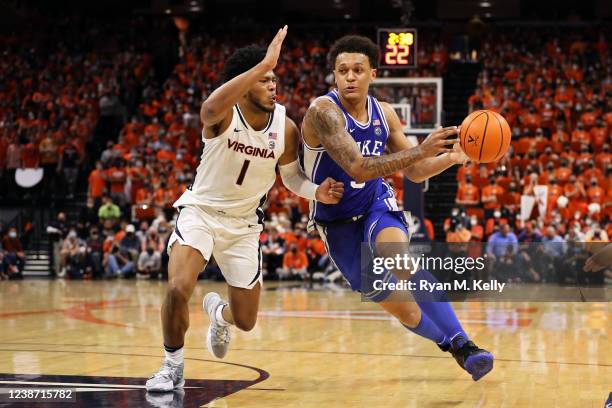 Paolo Banchero of the Duke Blue Devils drives against1 Jayden Gardner of the Virginia Cavaliers in the first half at John Paul Jones Arena on...