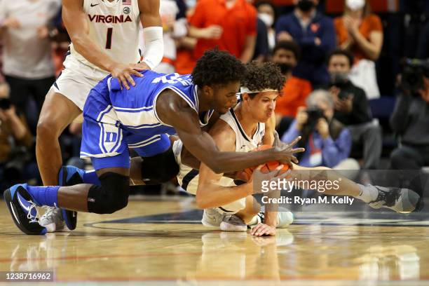 Griffin of the Duke Blue Devils and Kadin Shedrick of the Virginia Cavaliers go to the floor battling for a loose ball in the second half at John...