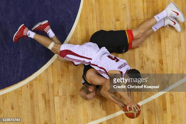 Chris Kaman of Germany and Dairis Bertrans of Latvia fight for the ball during the EuroBasket 2011 first round group B match between Latvia and...