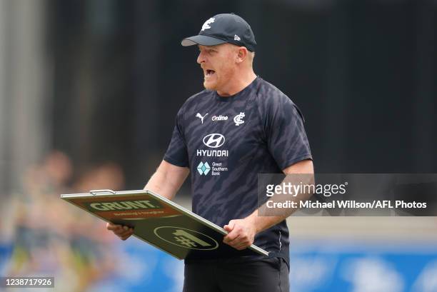 Senior coach Michael Voss of the Blues holds the coach's board during an AFL practice match between the Carlton Blues and the St Kilda Saints at Ikon...