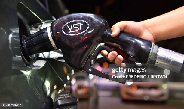 Gas is pumped into a vehicle in Los Angeles, California on February 23, 2022. - Stock markets mostly rose and oil prices held relatively steady on...