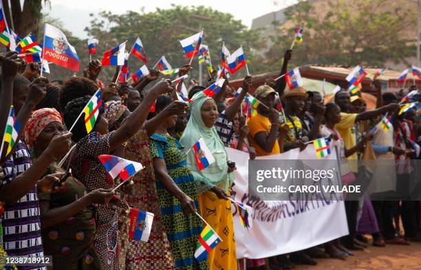 Demonstrators wave Russian flags during a pro Russia demonstration in Bangui on February 23, 2022. - A hundred Central Africans gathered in the...