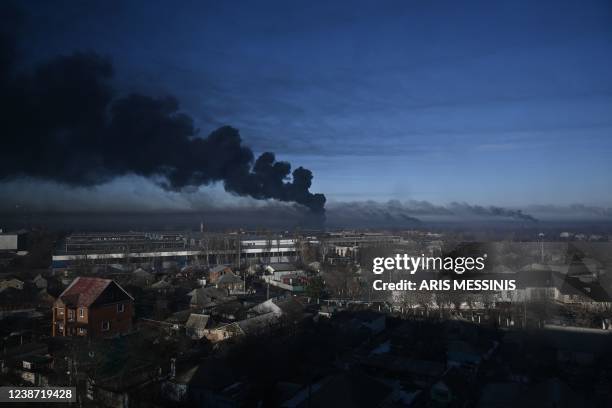 Black smoke rises from a military airport in Chuguyev near Kharkiv on February 24, 2022. - Russian President Vladimir Putin announced a military...