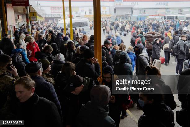 People wait for buses at a bus station as they attempt to evacuate the city on February 24, 2022 in Kyiv, Ukraine. Overnight, Russia began a...
