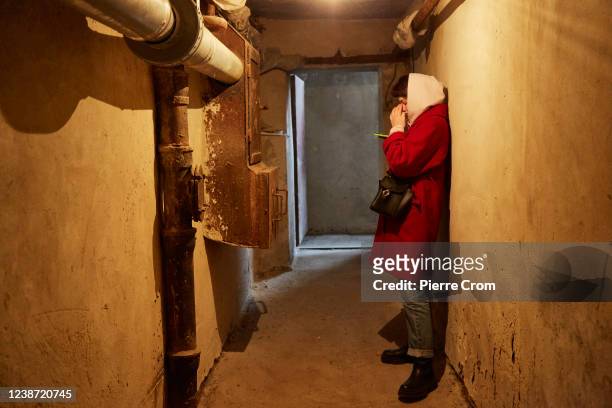 Local residents follow the news on their mobile devices in a bomb shelter on February 24, 2022 in Kyiv, Ukraine. Overnight, Russia began a...