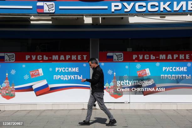 Man walks past a Russian supermarket in the Mediterranean seaside town of Limassol in southern Cyprus, on February 23, 2022. - Ukrainians living...