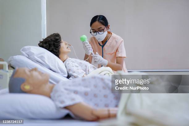 Nursing students attend physical classes inside a university in Manila, the Philippines on February 23, 2022. Schools gradually started reopening...