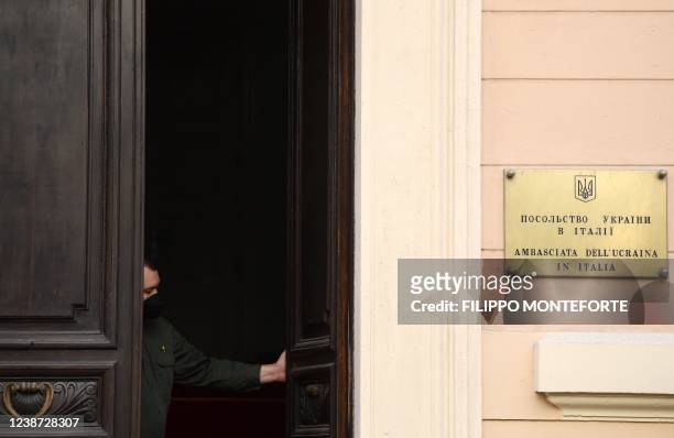 Security officer closes the door of the Ukraine's embassy in Rome on February 24, 2022. - Russia's ground forces invaded Ukraine from several...
