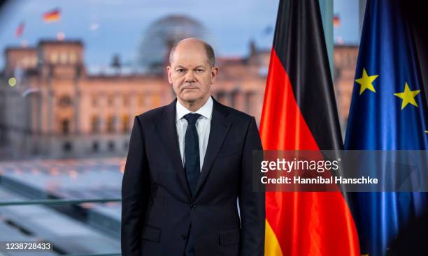 German Chancellor Olaf Scholz poses for pictures after he recorded a televised address to the nation following the Russian military invasion of...
