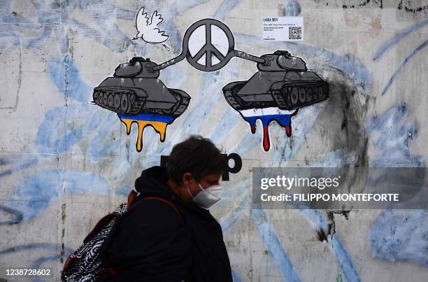 Painting on a house wall near the Russian's embassy in Rome on February 24 made by street artist Laika 1954, shows Russian and Ukrainian tanks makes...