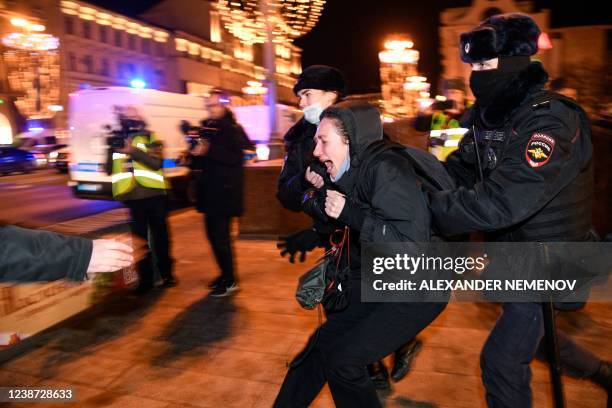 Police officers detain a demonstrator during a protest against Russia's invasion of Ukraine in Moscow on February 24, 2022. - Russian President...