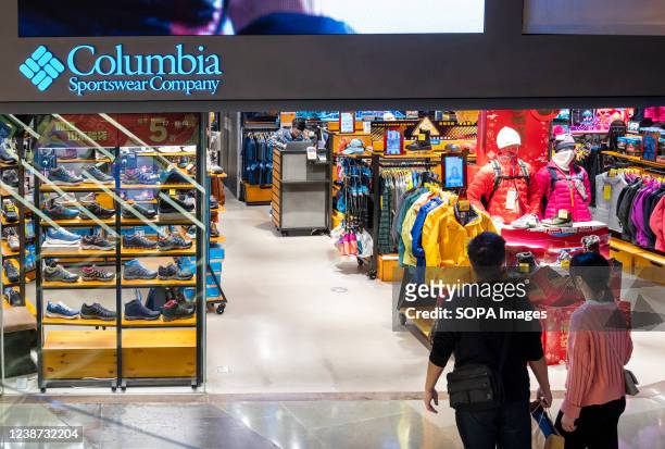 Couple walks in the American sportswear brand Columbia store in Hong Kong.