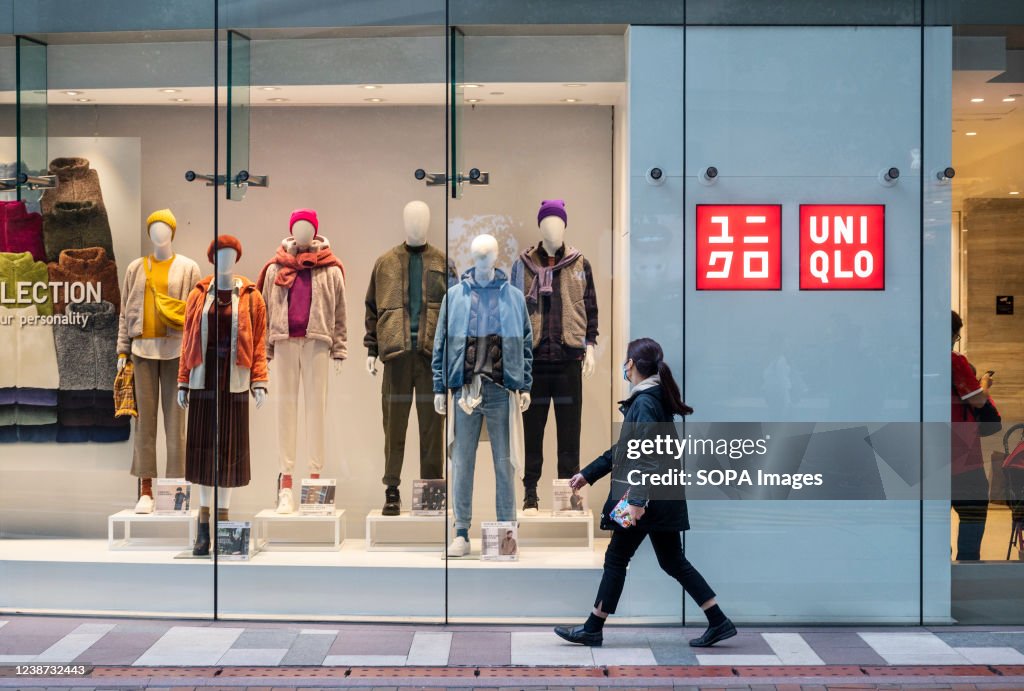 A pedestrian walks past the Japanese clothing brand store...