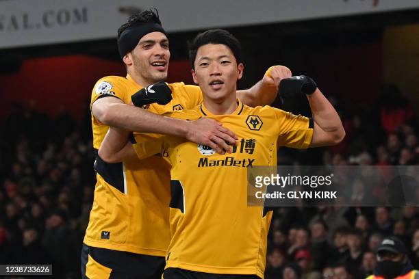 Wolverhampton Wanderers' South Korean striker Hwang Hee-chan celebrates with Wolverhampton Wanderers' Mexican striker Raul Jimenez after scoring the...