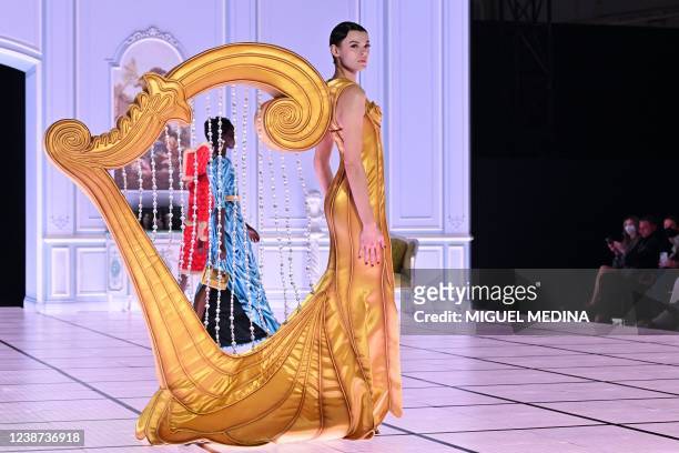 Model presents a creation during the Moschino catwalk show for the Fall/Winter 2022/2023 collection on the third day of the Milan Fashion Week in...
